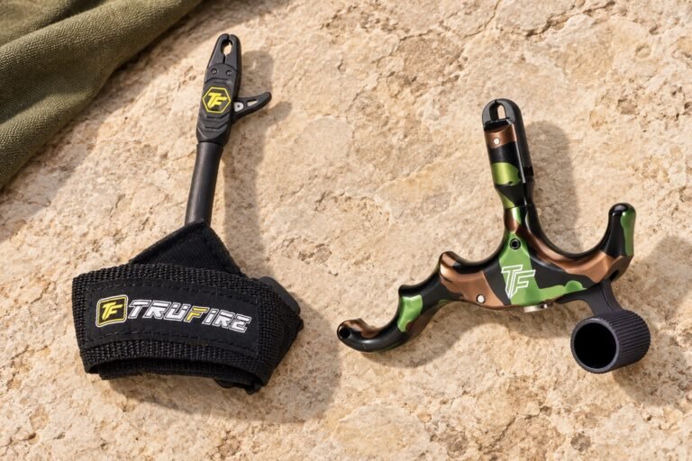 Tru-Fire Patriot wrist strap and Edge handheld releases on pale stone